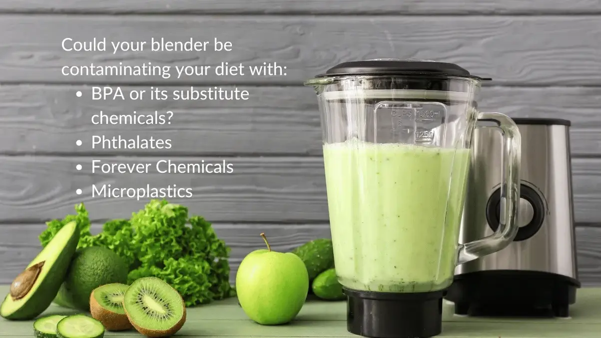 Blender with green smoothie amid fresh avocados kiwis apples cucumbers.